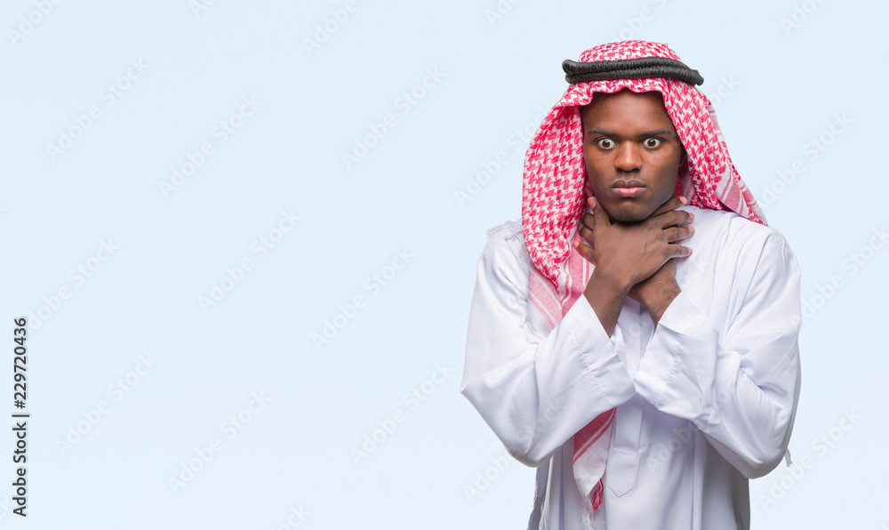 Man in keffiyeh standing against white background Man in keffiyeh standing against white background