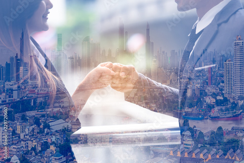 Double exposure of Business people of a Partnership Team Giving Fist Bump after complete deal. Successful Teamwork Partnership in an Office,city background