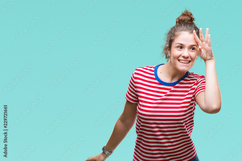 Beautiful brunette curly hair young girl wearing casual look over isolated background very happy and smiling looking far away with hand over head. Searching concept. Beautiful brunette curly hair young girl wearing casual look over isolated background very happy and smiling looking far away with hand over head. Searching concept.