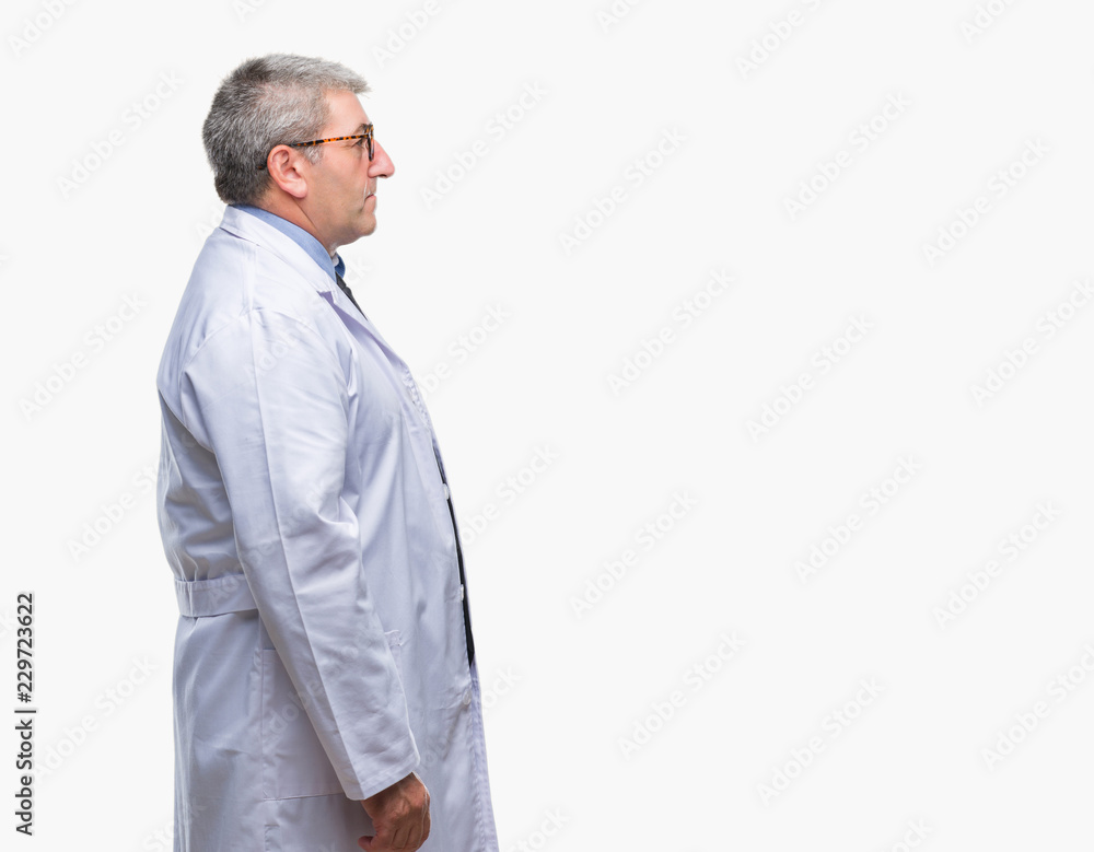 Handsome senior doctor, scientist professional man wearing white coat over isolated background looking to side, relax profile pose with natural face with confident smile. Handsome senior doctor, scientist professional man wearing white coat over isolated background looking to side, relax profile pose with natural face with confident smile.