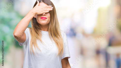 Young beautiful woman casual white t-shirt over isolated background smiling and laughing with hand on face covering eyes for surprise. Blind concept. Free Download Young beautiful woman casual white t-shirt over isolated background smiling and laughing with hand on face covering eyes for surprise. Blind concept. - GFXLoad