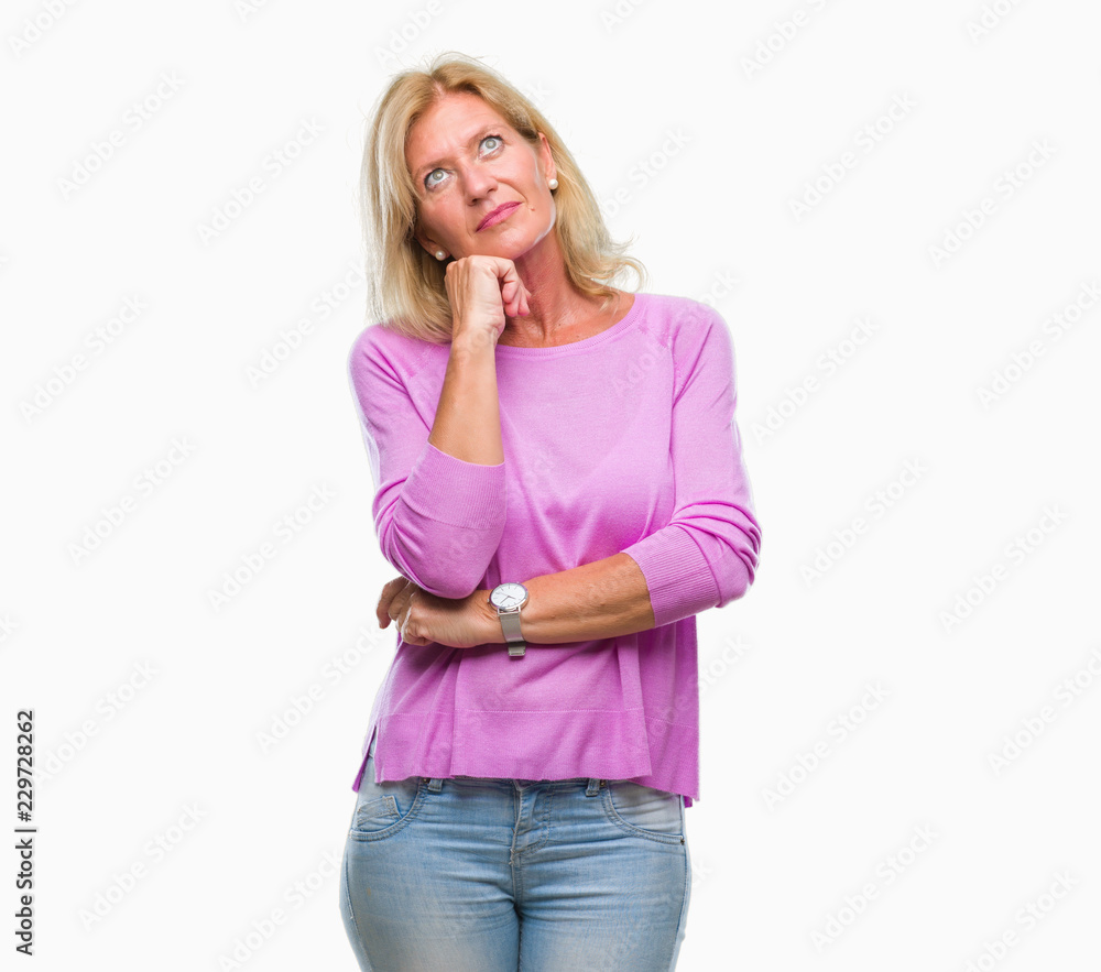 Middle age blonde woman over isolated background with hand on chin thinking about question, pensive expression. Smiling with thoughtful face. Doubt concept. Middle age blonde woman over isolated background with hand on chin thinking about question, pensive expression. Smiling with thoughtful face. Doubt concept.