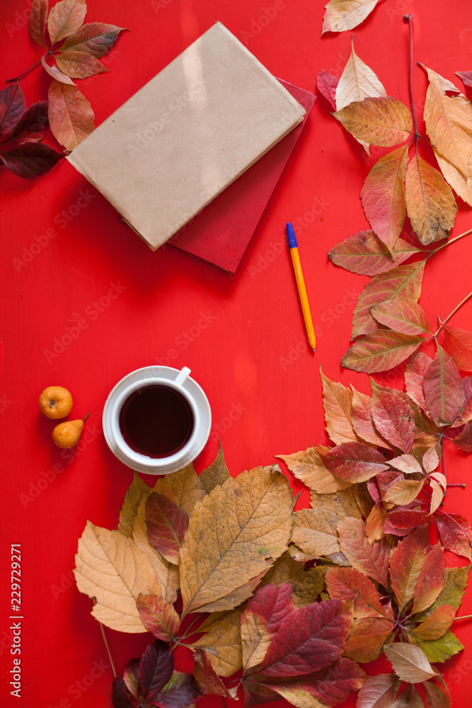 Autumn leaves book coffee cup on a red background