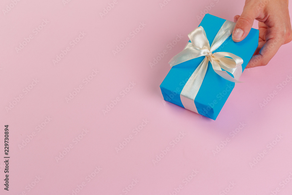 Woman holding gift box on color background Woman holding gift box on color background