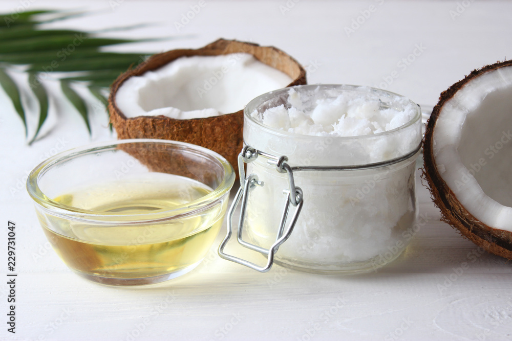 coconuts and coconut oil on a wooden background. coconuts and coconut oil on a wooden background.