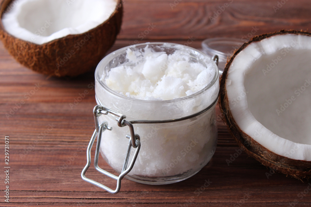 coconuts and coconut oil on a wooden background. coconuts and coconut oil on a wooden background.