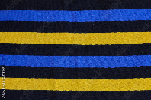 Texture of warm knitted striped clothes