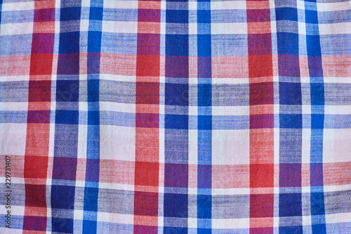 Texture of warm knitted plaid clothing.