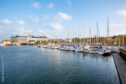 Landscape view on the harbour with beautiful yachts and buildings during the morning light in Deauvillle village in France