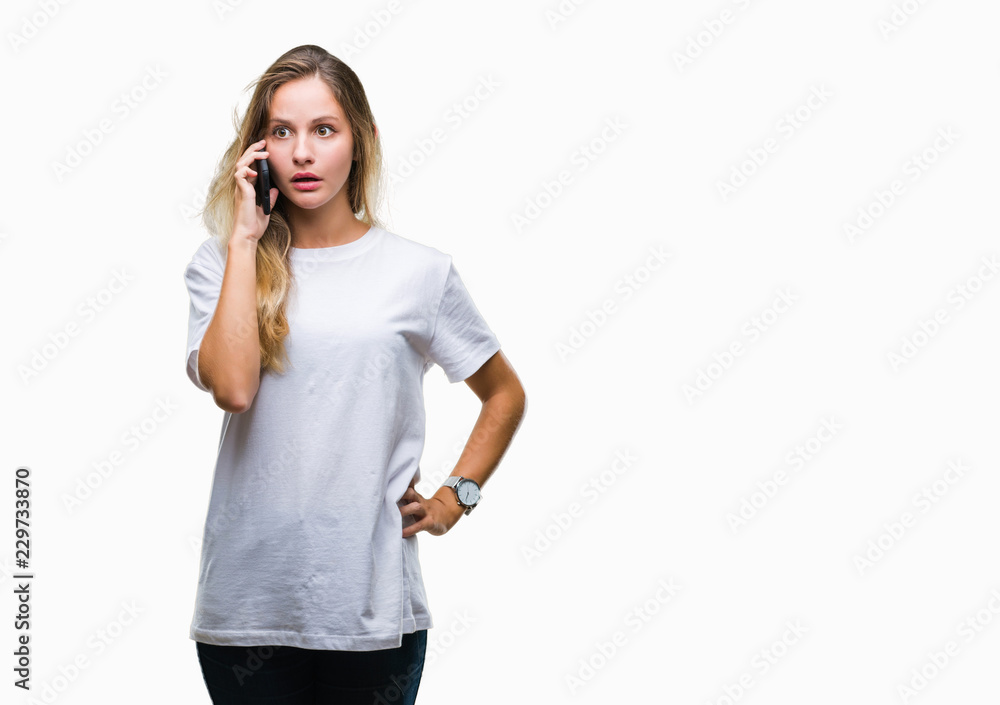 Young beautiful blonde woman calling using smartphone over isolated background scared in shock with a surprise face, afraid and excited with fear expression Young beautiful blonde woman calling using smartphone over isolated background scared in shock with a surprise face, afraid and excited with fear expression