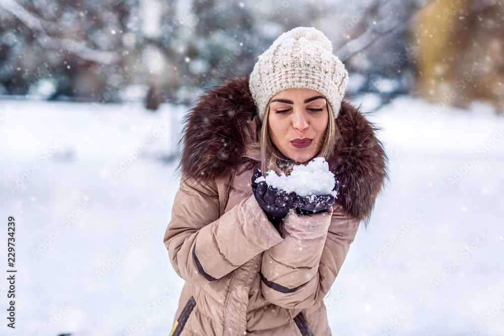 beautiful girl blowing magic snow. Christmas magic.. beautiful girl blowing magic snow. Christmas magic..