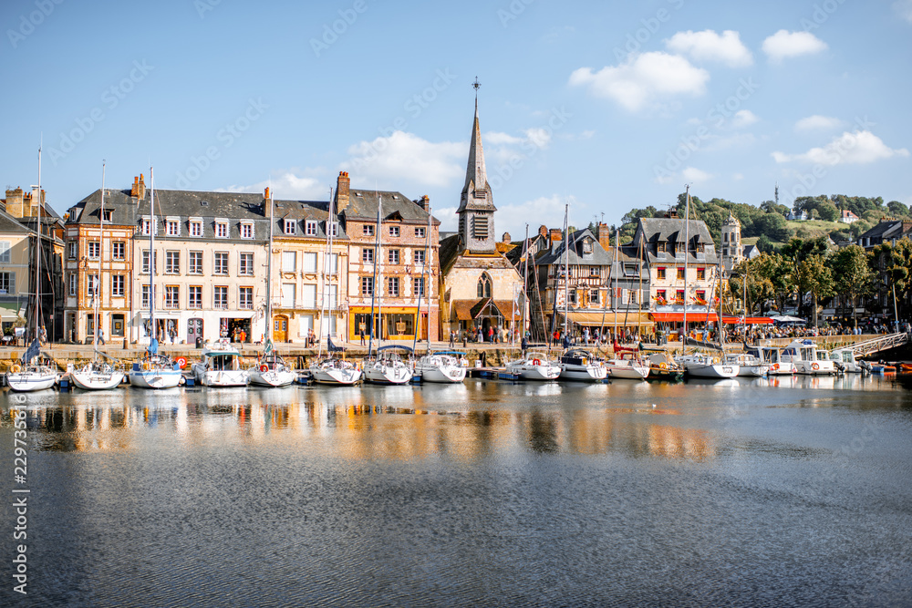 Waterside with ancient buildings and church in Honfleur, famous french town in Normandy