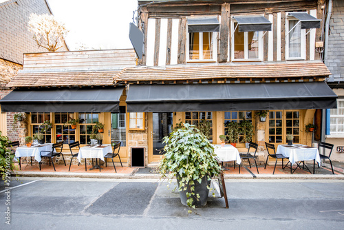 Old building facade with beautiful restaurant in Honfleur, famuos french town in Normandy