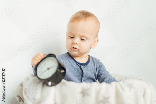 The concept of a happy childhood and safety. Portrait of a crawling baby. Good night. Children's clothing. Good morning. Son. photo