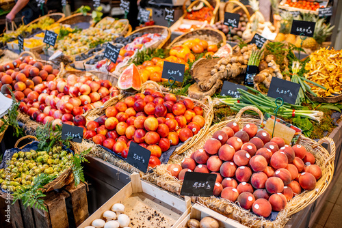 Fototapeta Naklejka Na Ścianę i Meble -  Variety of beautifully organized fruits and vegetables on the counter of the market place