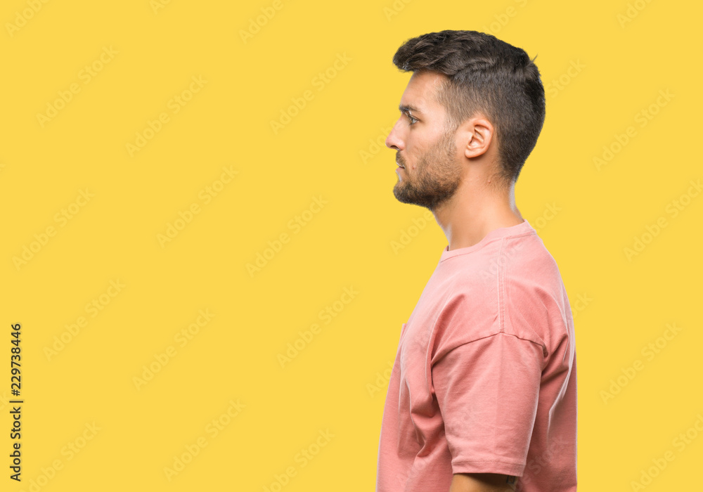 Young handsome man over isolated background looking to side, relax profile pose with natural face with confident smile. Young handsome man over isolated background looking to side, relax profile pose with natural face with confident smile.