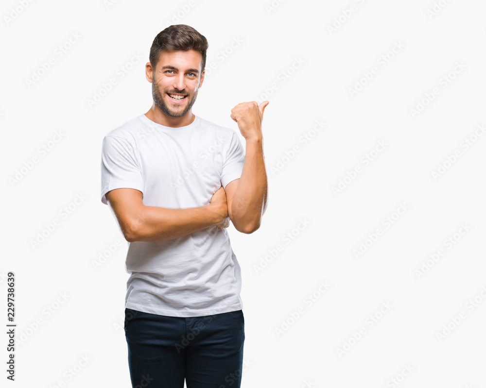 Young handsome man over isolated background smiling with happy face looking and pointing to the side with thumb up. Young handsome man over isolated background smiling with happy face looking and pointing to the side with thumb up.