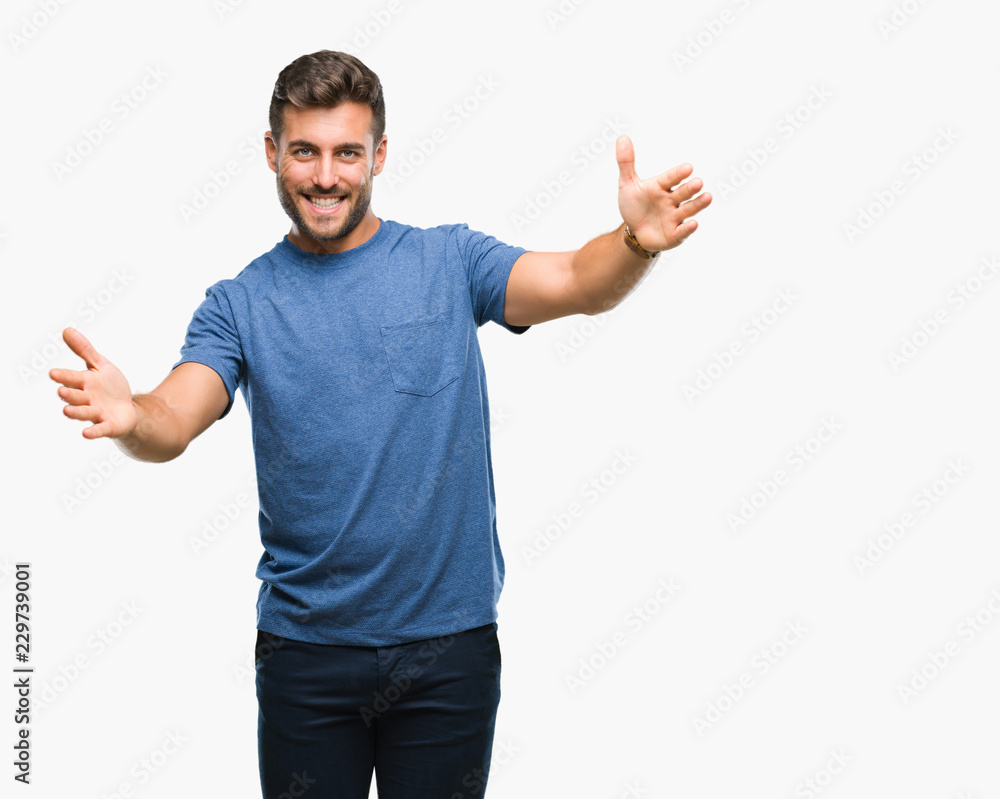 Young handsome man over isolated background looking at the camera smiling with open arms for hug. Cheerful expression embracing happiness. Young handsome man over isolated background looking at the camera smiling with open arms for hug. Cheerful expression embracing happiness.