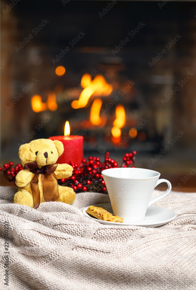 Cup Of Hot Drink With Steam Teddy Bear Candle In Red Christmas Decoration  On Cozy Knitted Plaid In Front Of Fireplace Cozy Magical Atmosphere In Home  Interior Holiday Christmas New Year Concept