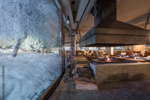 Big window in winter night and restaurant interior