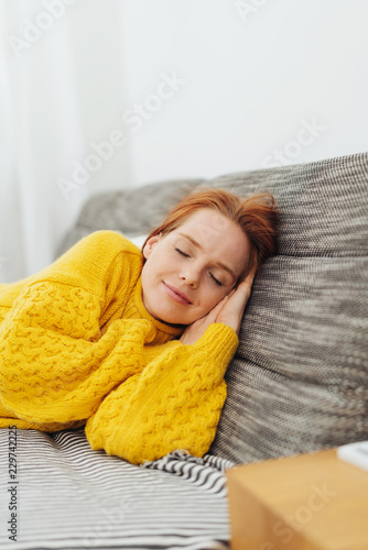 Attractive redhead woman taking a nap