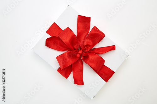 single gift box with red ribbon © 1981 Rustic Studio
