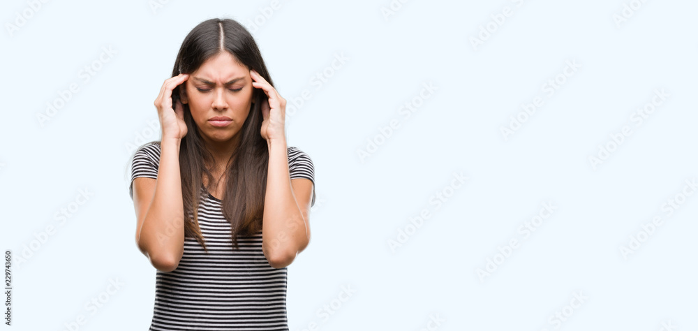 Young beautiful hispanic woman with hand on head for pain in head because stress. Suffering migraine. Young beautiful hispanic woman with hand on head for pain in head because stress. Suffering migraine.
