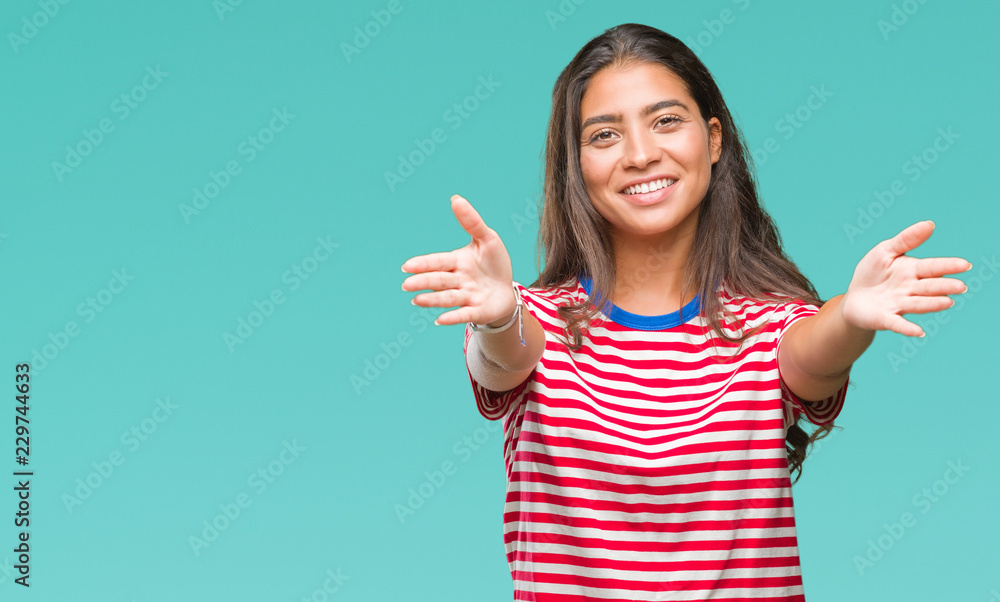 Young beautiful arab woman over isolated background looking at the camera smiling with open arms for hug. Cheerful expression embracing happiness. Young beautiful arab woman over isolated background looking at the camera smiling with open arms for hug. Cheerful expression embracing happiness.