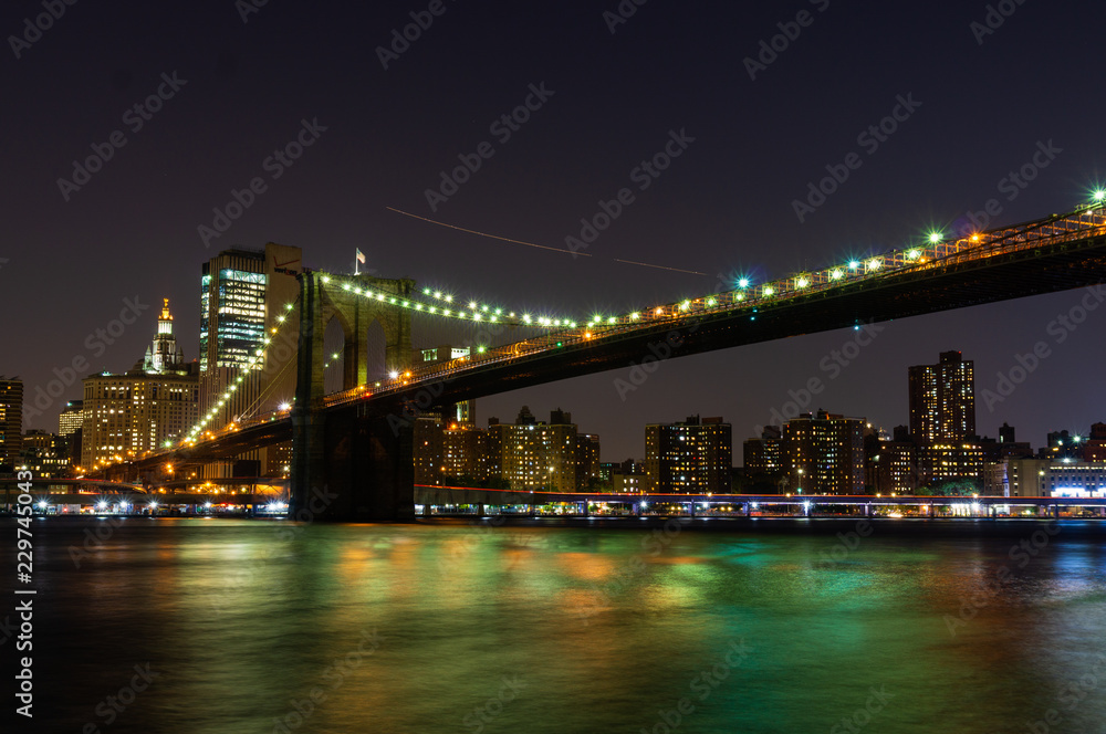 Long time exposure of New York City Brooklyn Bridge  at night viewed from Brooklyn Bridge park