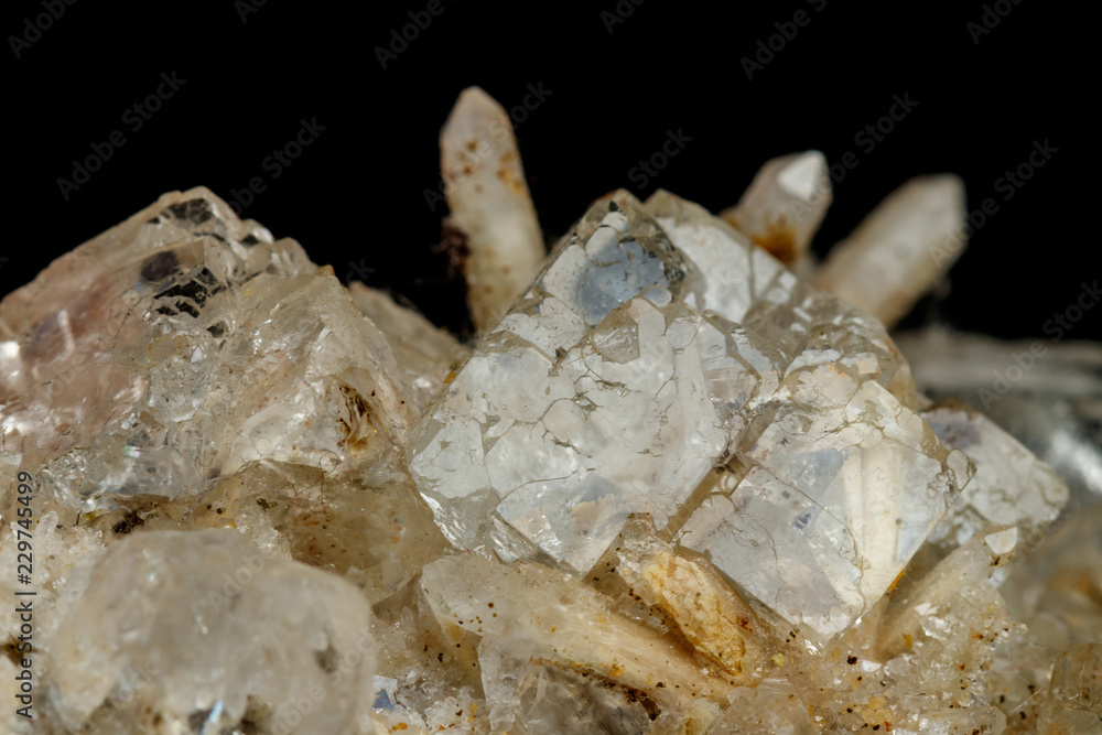 Macro mineral stone fluorite with quartz against black background Macro mineral stone fluorite with quartz against black background