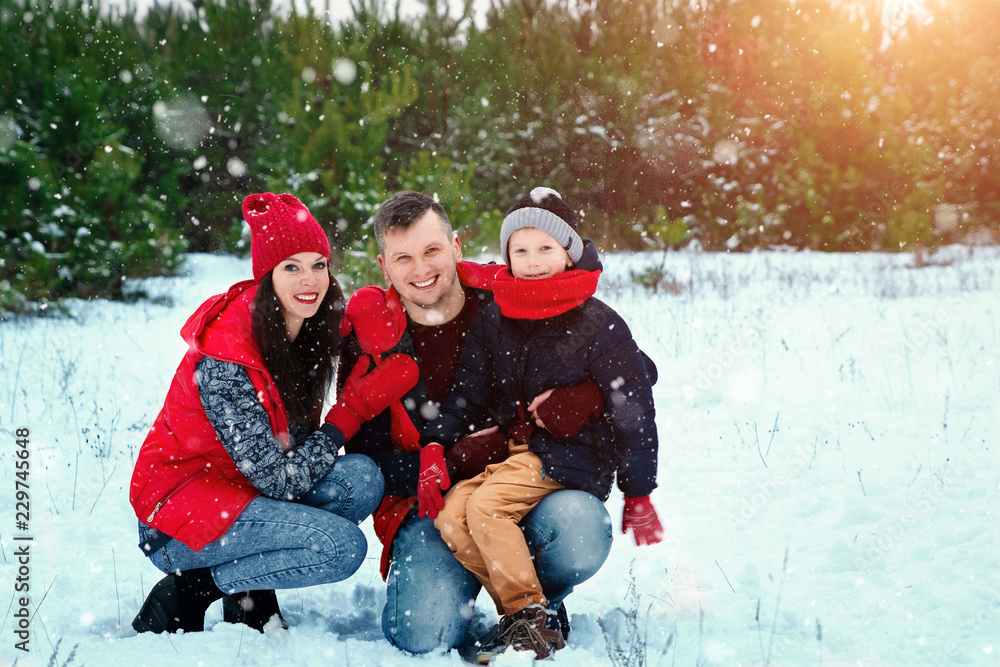 Happy family in warm clothes in the winter outdoors. Concept of holidays, holidays, winter, new year, day of grace. Family relationships, happy marriage.