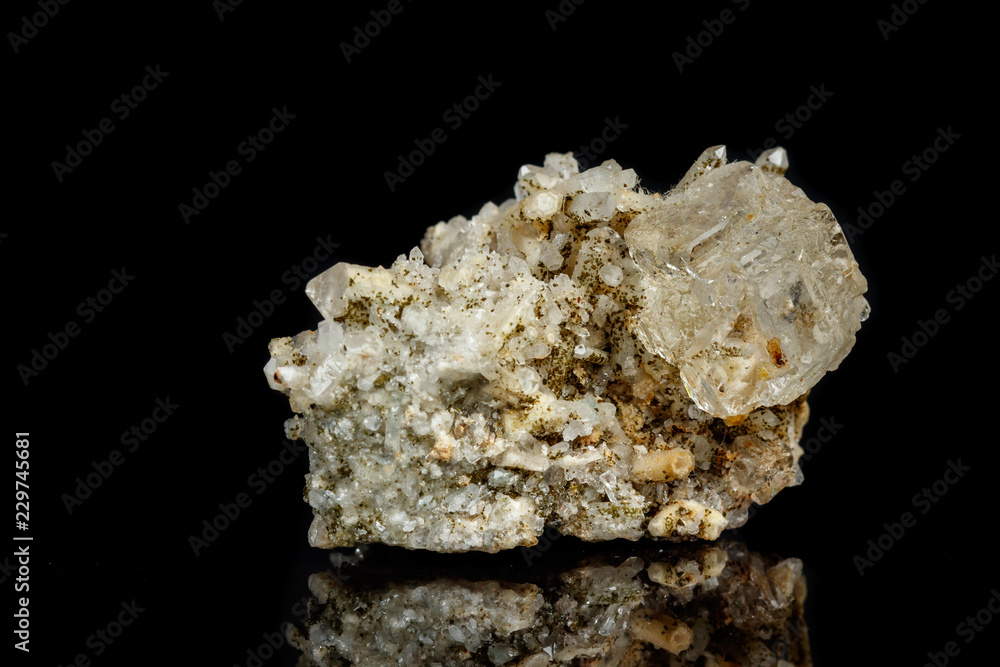 Macro mineral stone fluorite with quartz against black background Macro mineral stone fluorite with quartz against black background