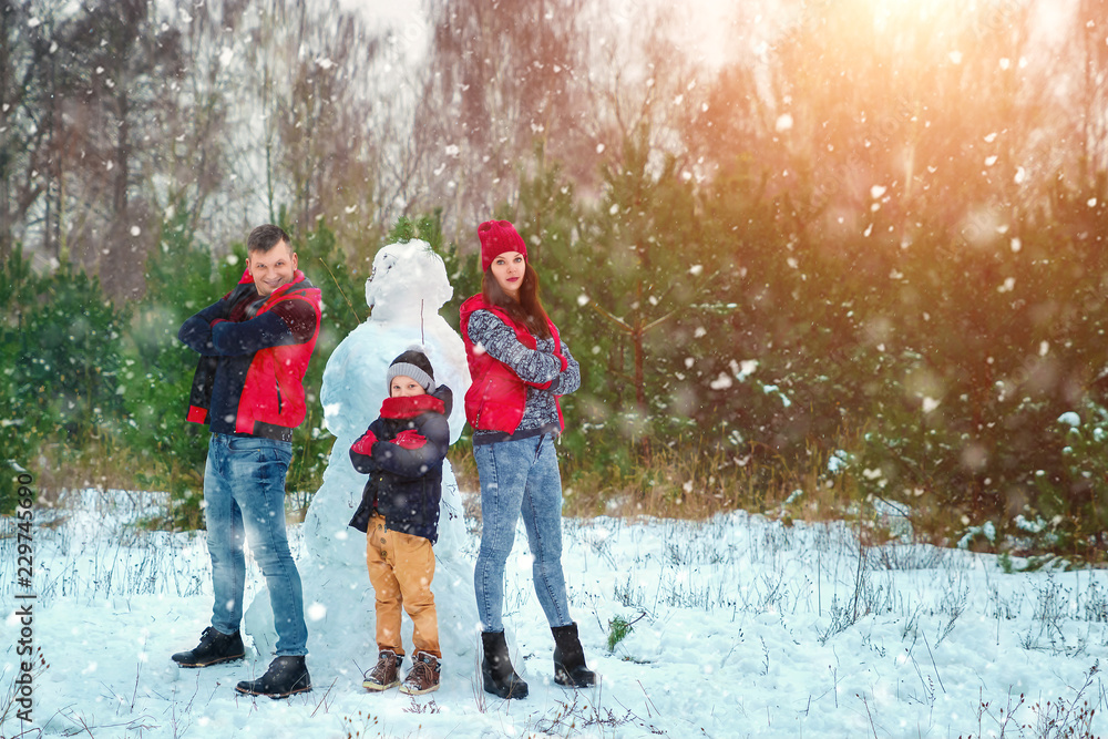 Happy family in warm clothes in the winter outdoors. Concept of holidays, holidays, winter, new year, day of grace. Family relationships, happy marriage. Happy family in warm clothes in the winter outdoors. Concept of holidays, holidays, winter, new year, day of grace. Family relationships, happy marriage.