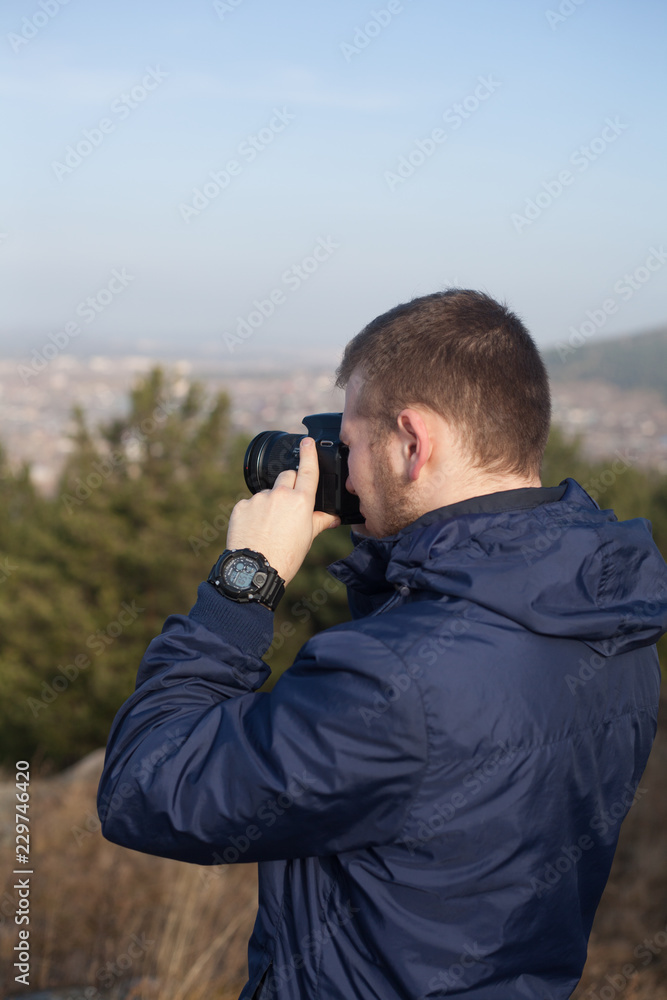 Nature photographer with digital camera on top of the mountain Nature photographer with digital camera on top of the mountain