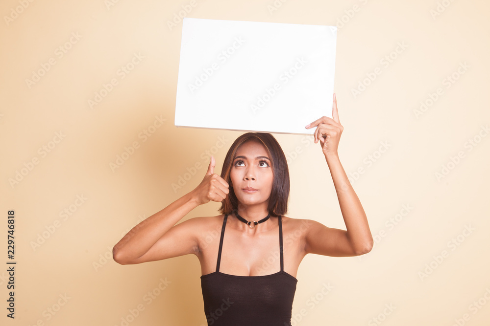Young Asian woman show thumbs up with white blank sign. Young Asian woman show thumbs up with white blank sign.