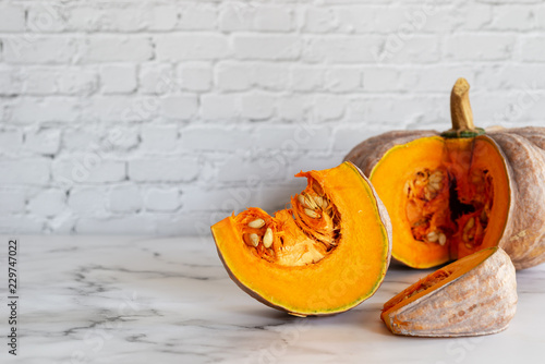 sliced raw pumpkin on marblel table background. photo