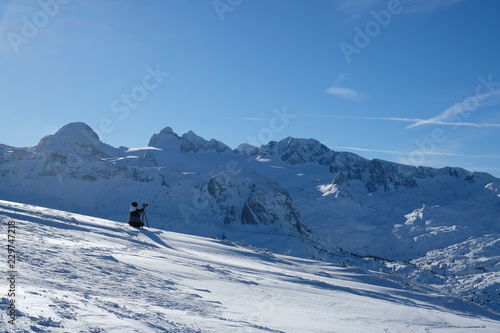 the photographer takes pictures of the winter landscape in the mountains