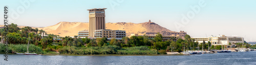 The Nile at Aswan and the West Bank with Tombs of the Nobles (from the Old and Middle Kingdom). There is Qubbet el-Hawa - 'Dome of the Winds' (tomb of a Muslim prophet) at the crest of the hill photo