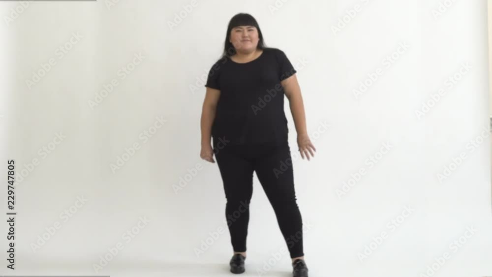 authentic fat Asian girl dancing and enjoying life on white background. Life outside of the stereotypes of today's youth. Concept idea authentic fat Asian girl dancing and enjoying life on white background. Life outside of the stereotypes of today's youth. Concept idea