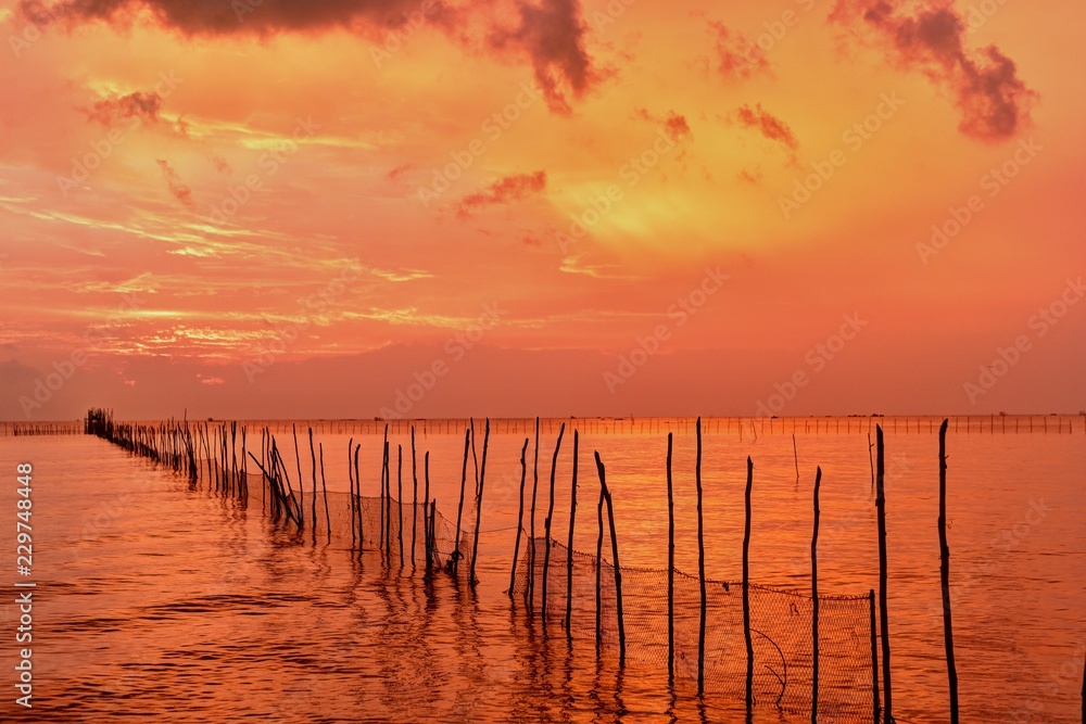 Row of Sticks in the sea and sunset at Belitung Island, Indonesia