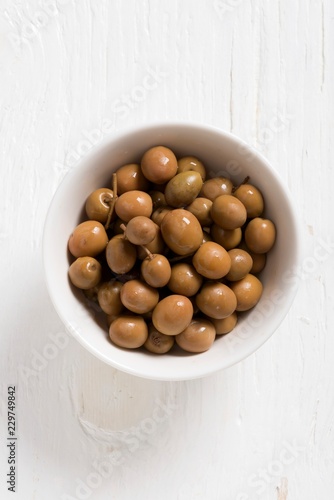 Spanish Albequina olives in a white bowl photo