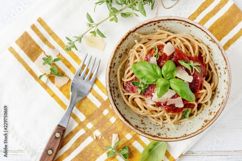 Plate of spaghettis with tomato sauce and basil photo
