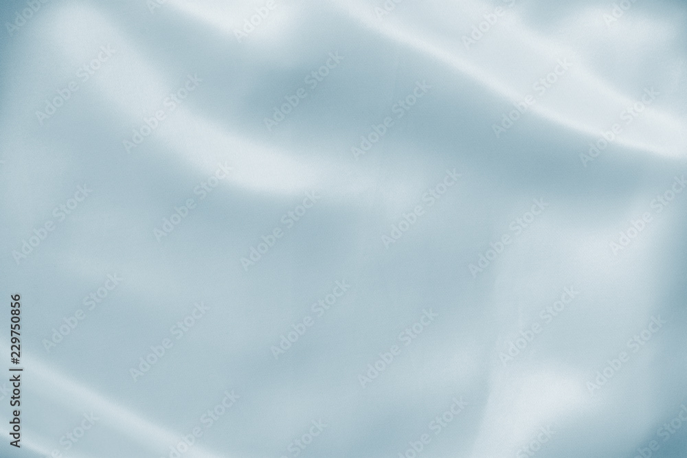 Abstract crumpled white light blue wedding background with silk, satin or cloth folds and drapes fabric texture. Luxury cloth,wavy grunge satin textured velvet material or luxurious Christmas holiday.