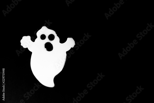 Cute white ghost isolated on black. Halloween background