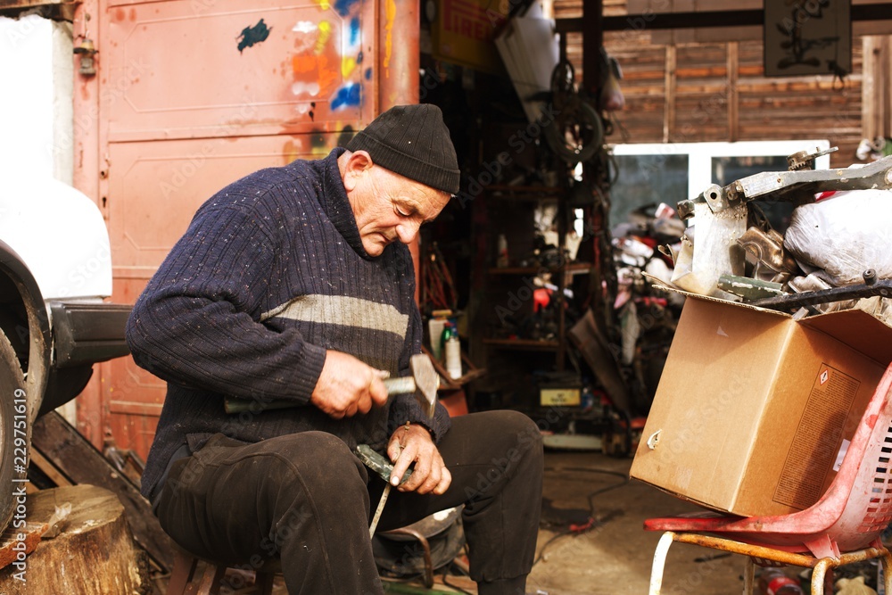 senior man working at garage, senior man working at garage,