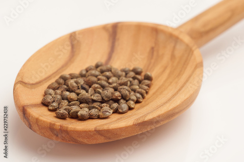 Hemp seeds on wooden spoon