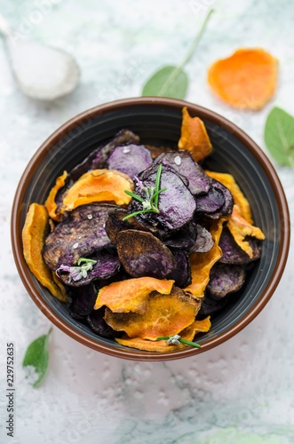 Overhead view of sweet potato and blue potato crisps in bowl photo