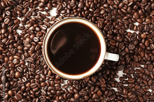 Cup of coffee on roasted beans