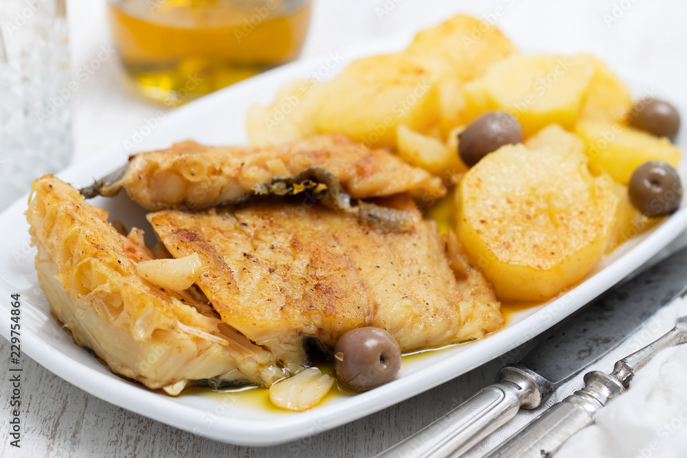 cod fish with fried potato on white dish cod fish with fried potato on white dish