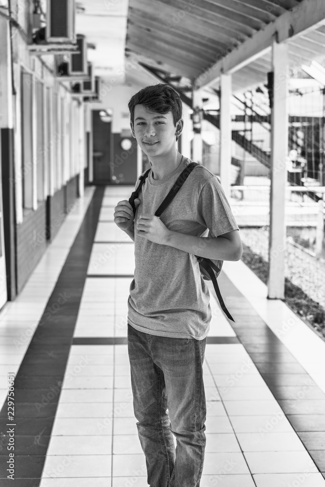 Caucasian boy in school hallway